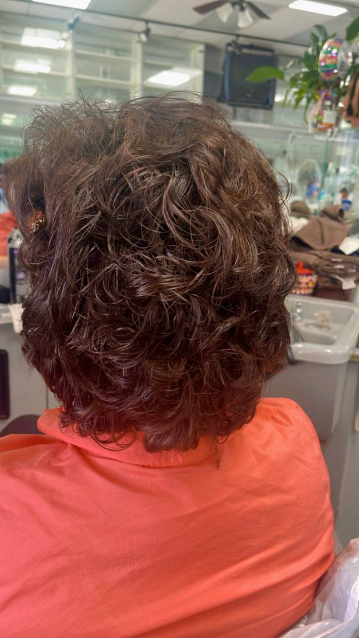 Short brunette perm with soft, glossy bounce