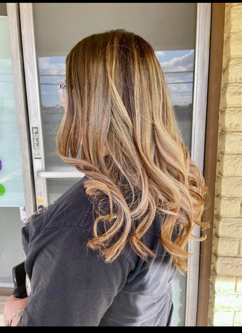 Long caramel balayage with soft curled ends
