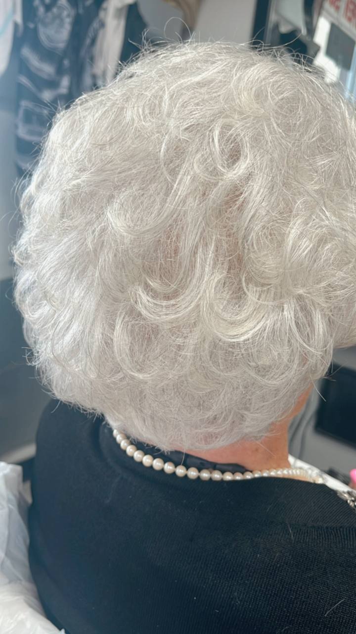 Soft silver curls set above a pearl necklace