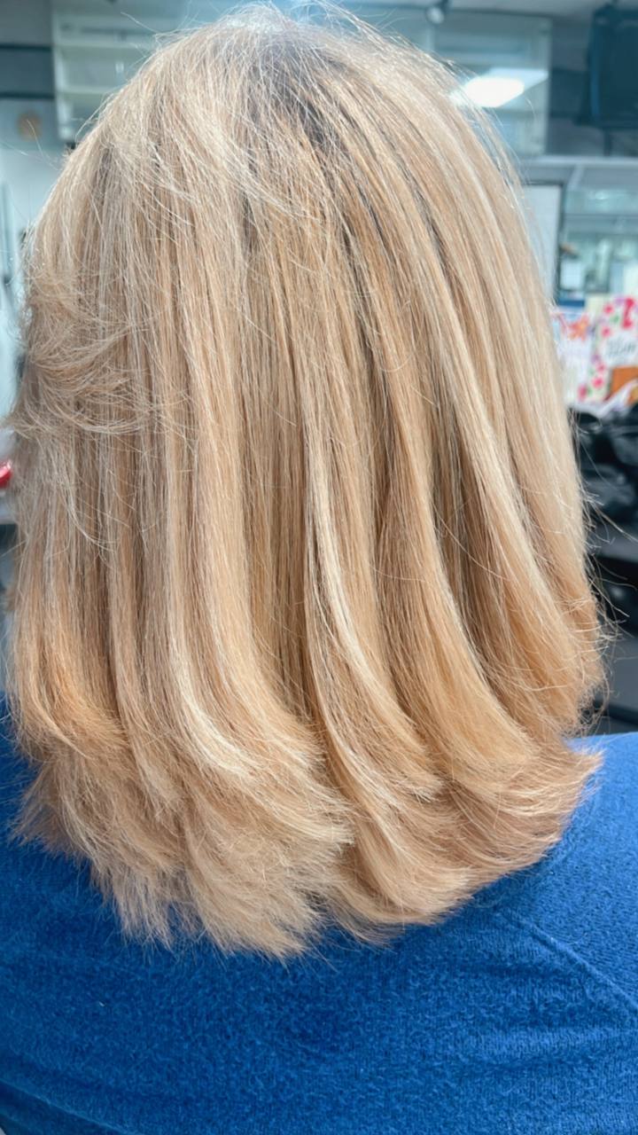 Golden blonde blowout with a soft bend at the ends