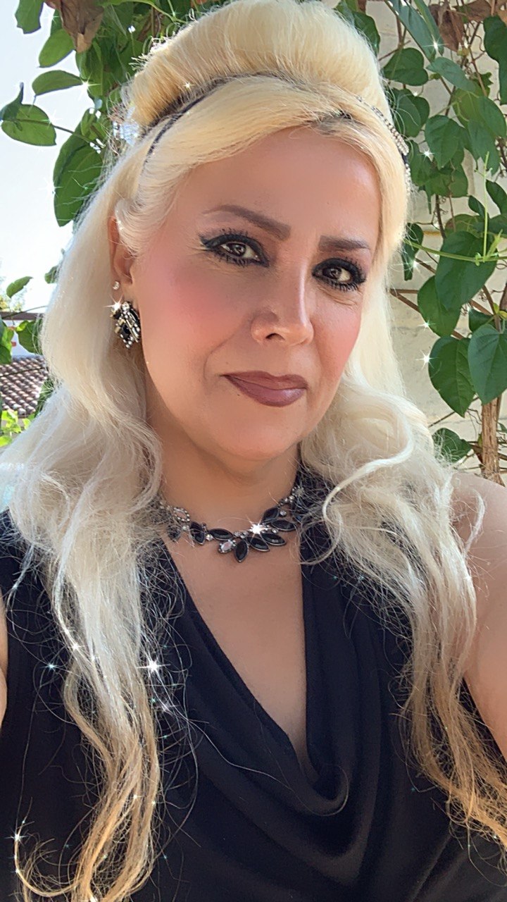 Me — Nas, hair swept up, smiling in the afternoon sun