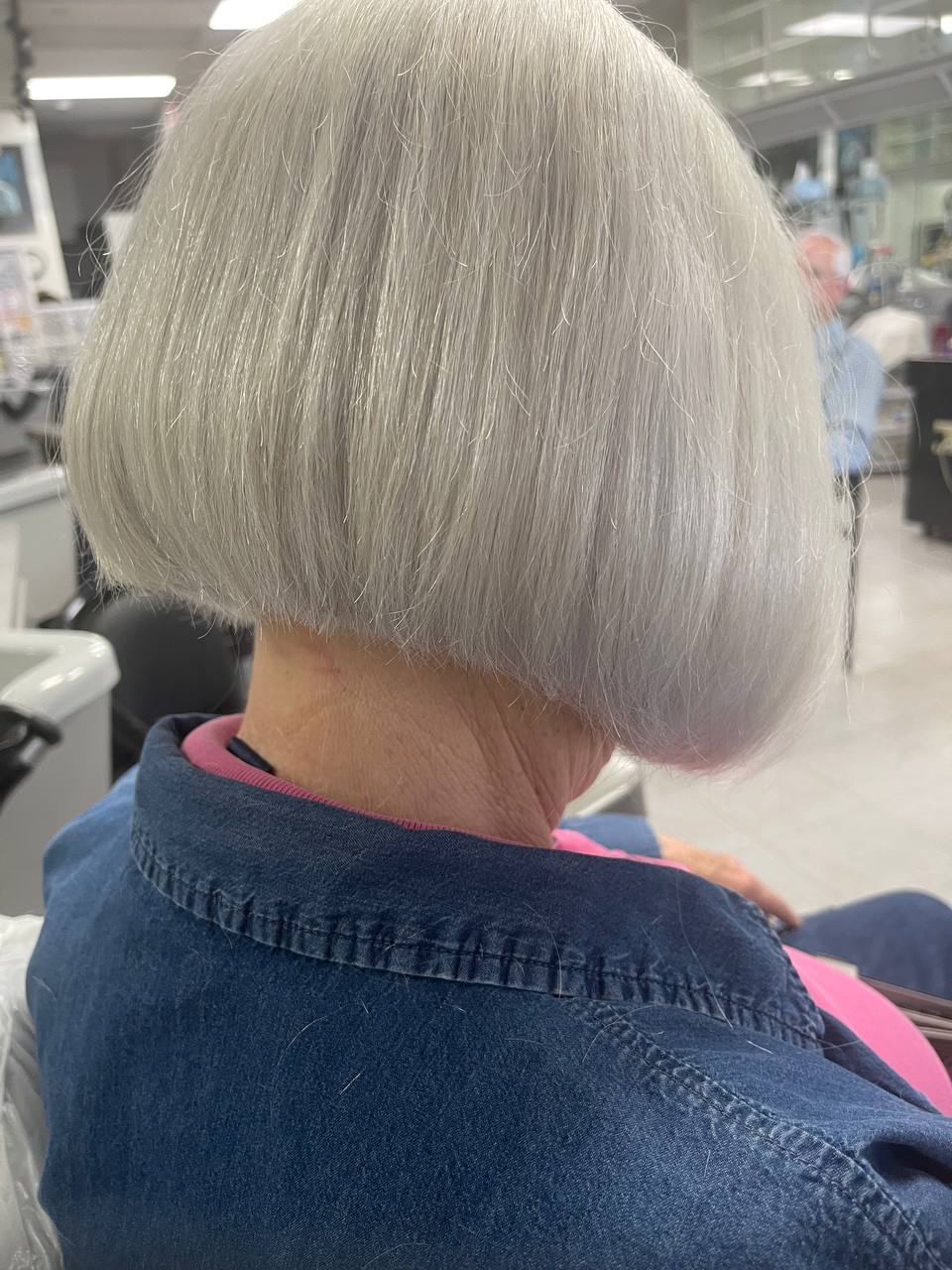 Sleek silver bob cut to a clean, rounded line