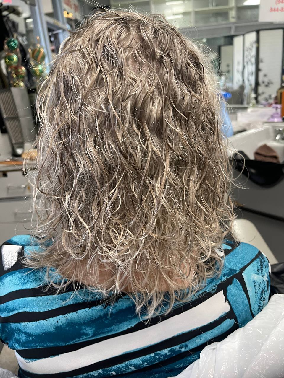 Shoulder-length ash-blonde waves with silver tones